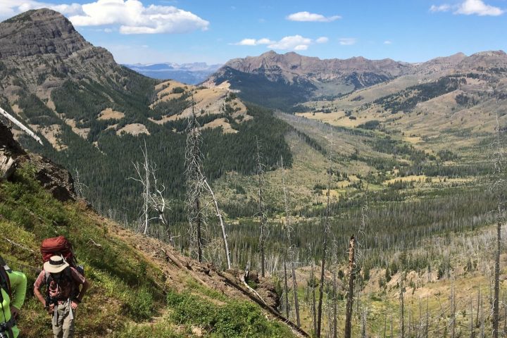 a man standing in front of a mountain
