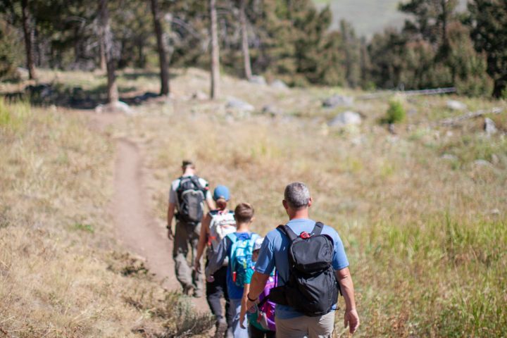 a man riding a bike down a dirt road