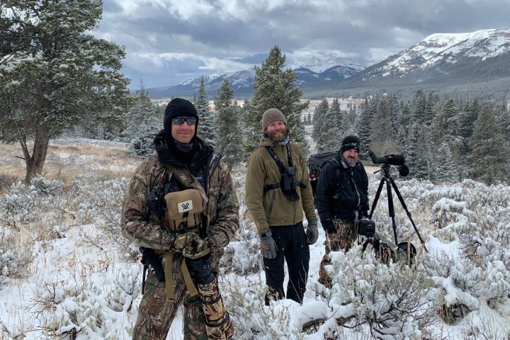 a couple of people that are standing in the snow