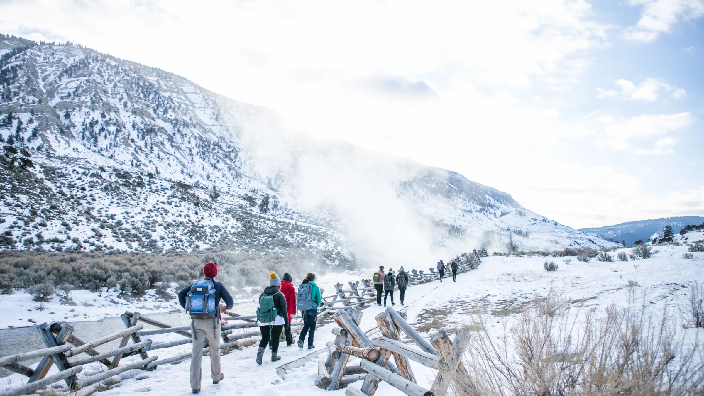 a group of people standing on top of a snow covered mountain