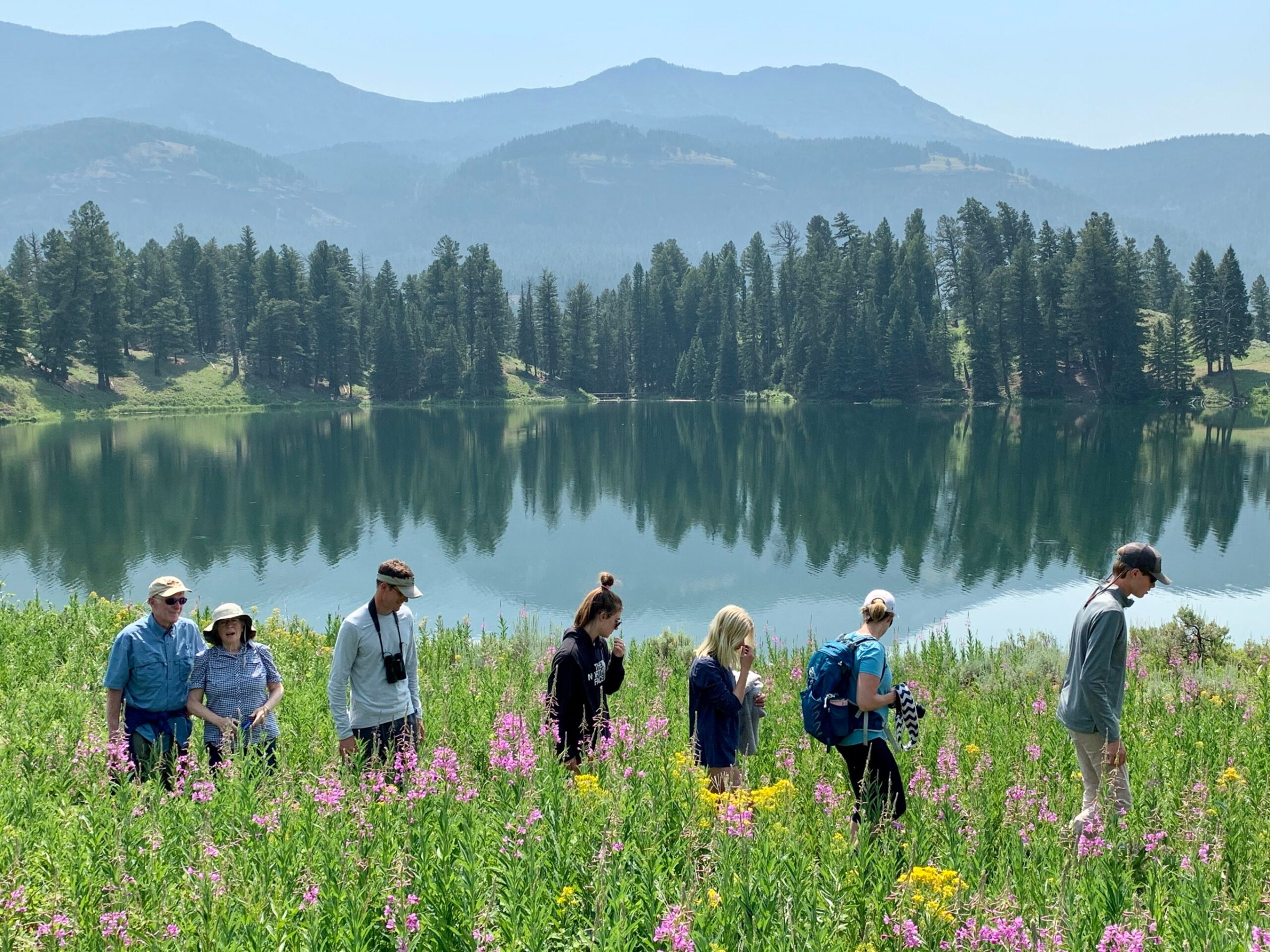 group hiking by a mountain lake