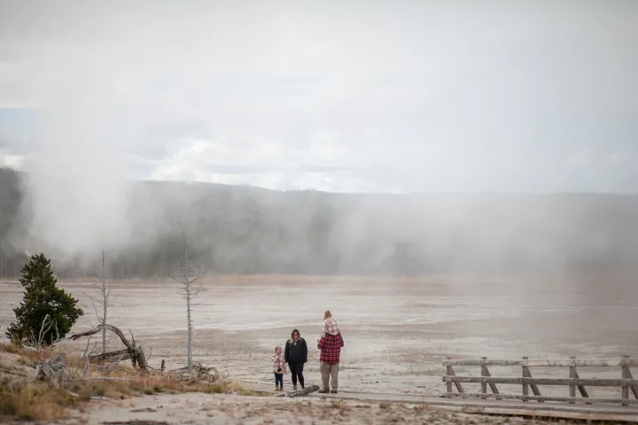 a group of people walking down a dirt road