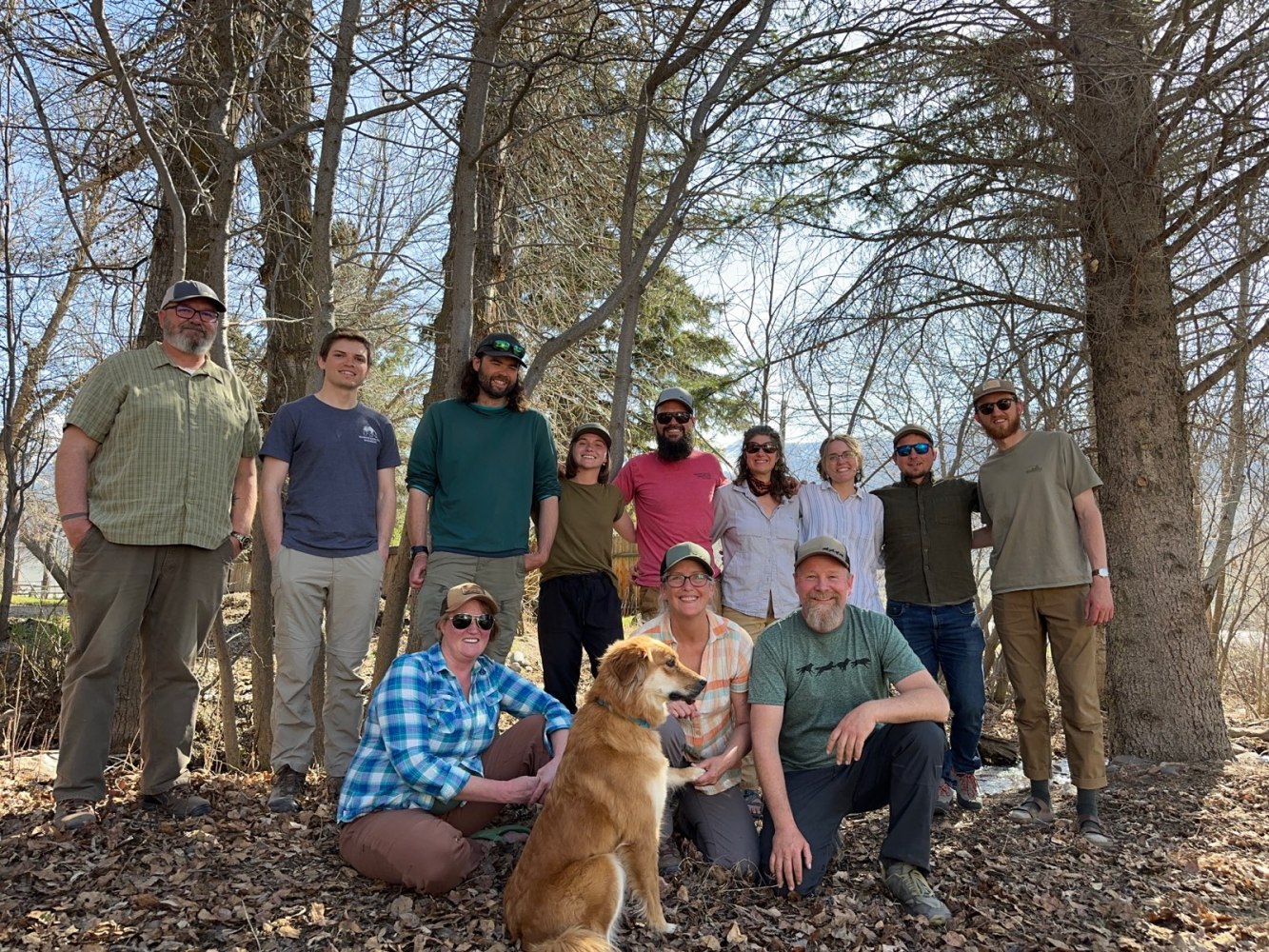 a group of people posing for a picture with a dog