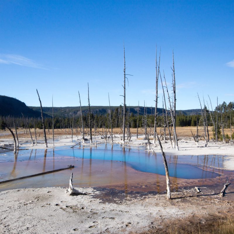 a boat sitting on top of a sandy beach