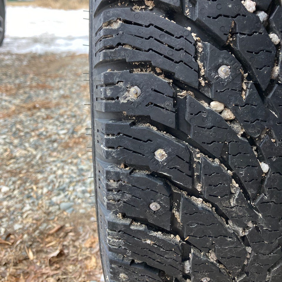 Studded snow tires are among the safety precautions Yellowstone Wild Tours employs for a safe winter tour experience for guests on winter tours in Yellowstone National Park.