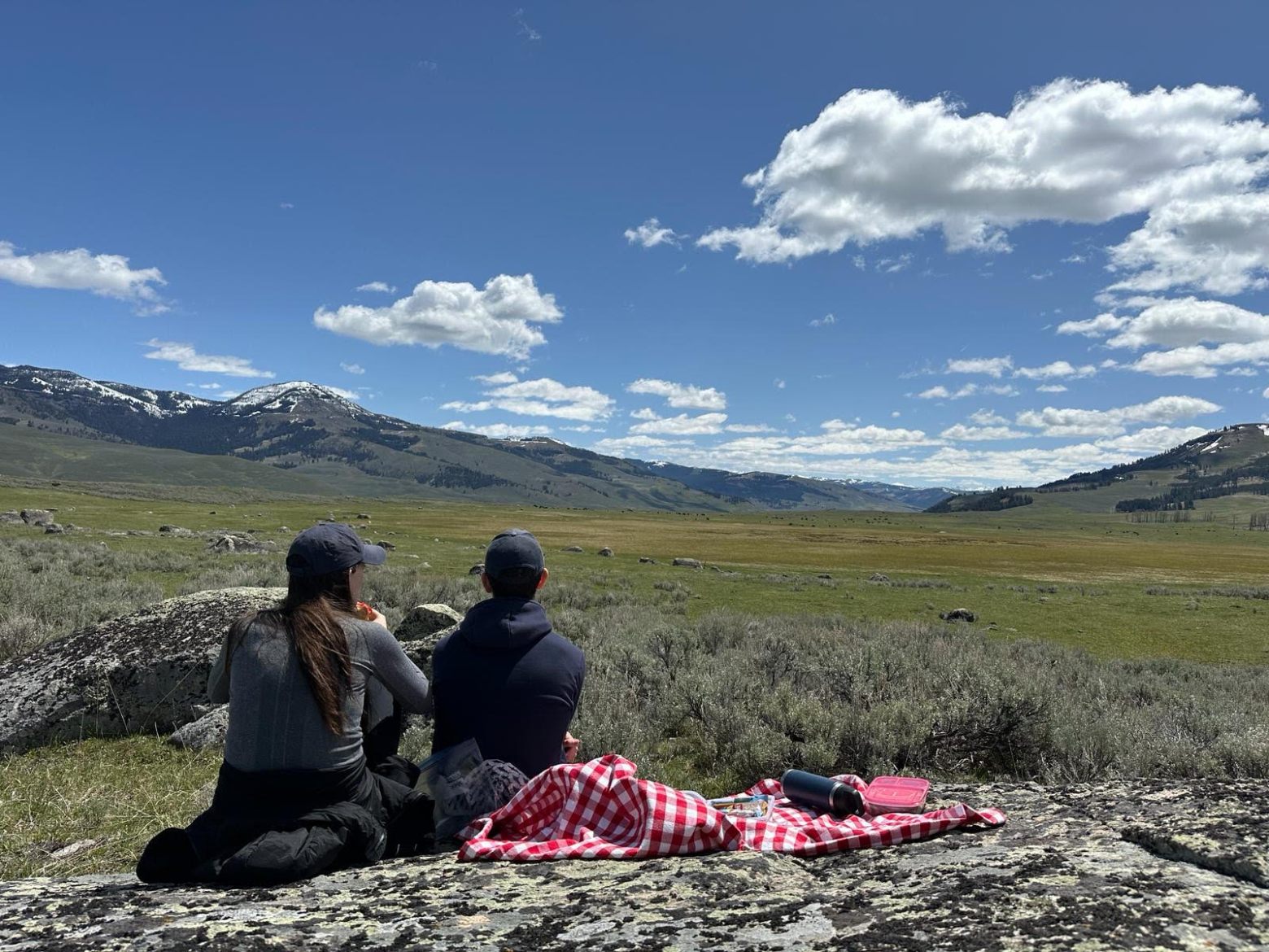 a man sitting on top of a mountain