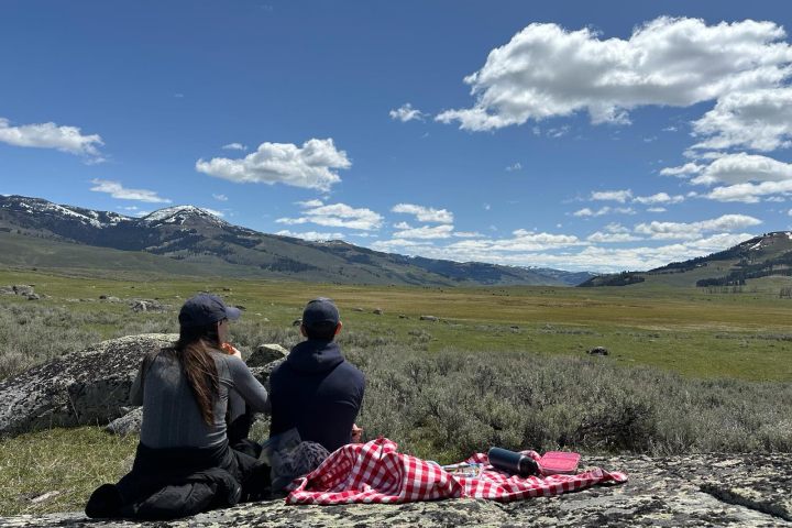 a man sitting on top of a mountain