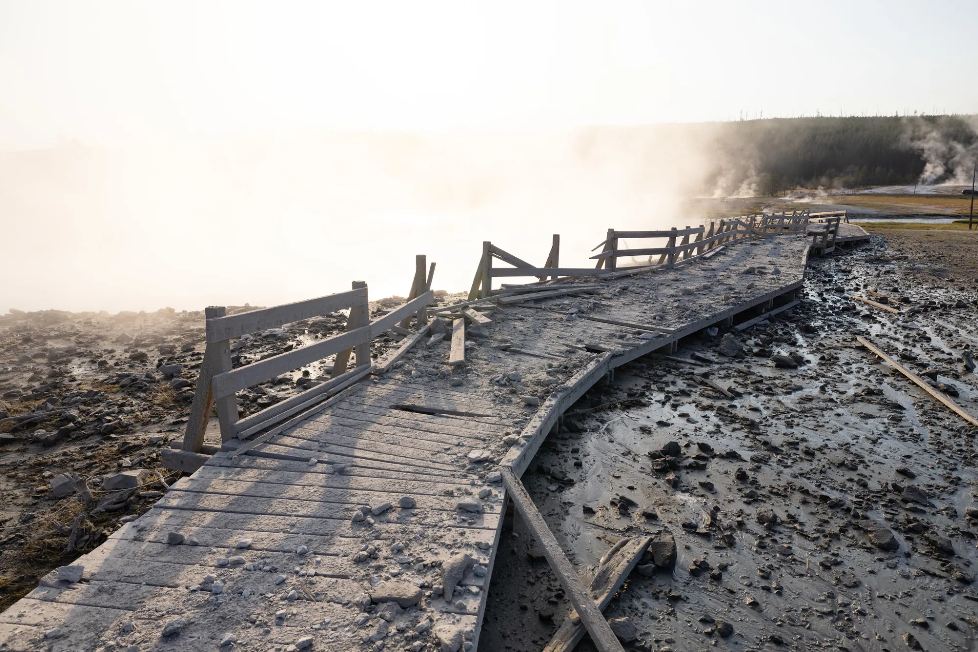 Biscuit Basin boardwalk post-explosion – NPS Jacob W. Frank a group of people on a dirt track