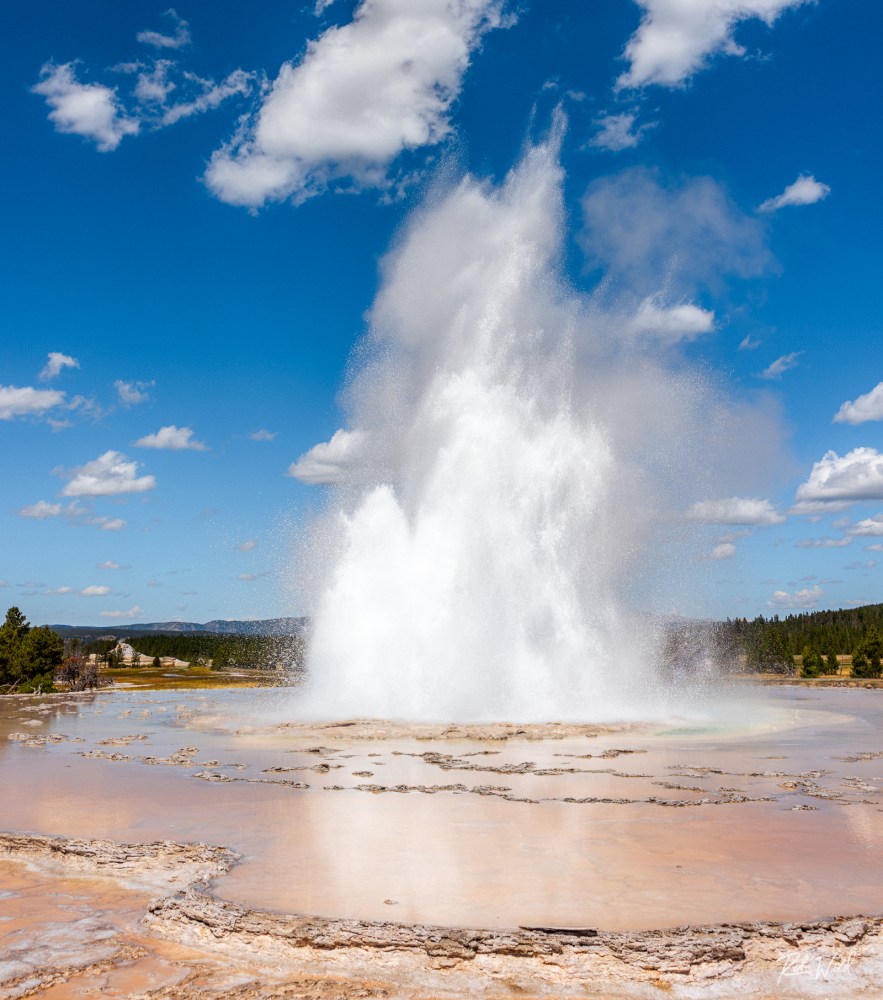 Great Fountain Geyser in eruption with magnificent reflections in the surrounding terraces