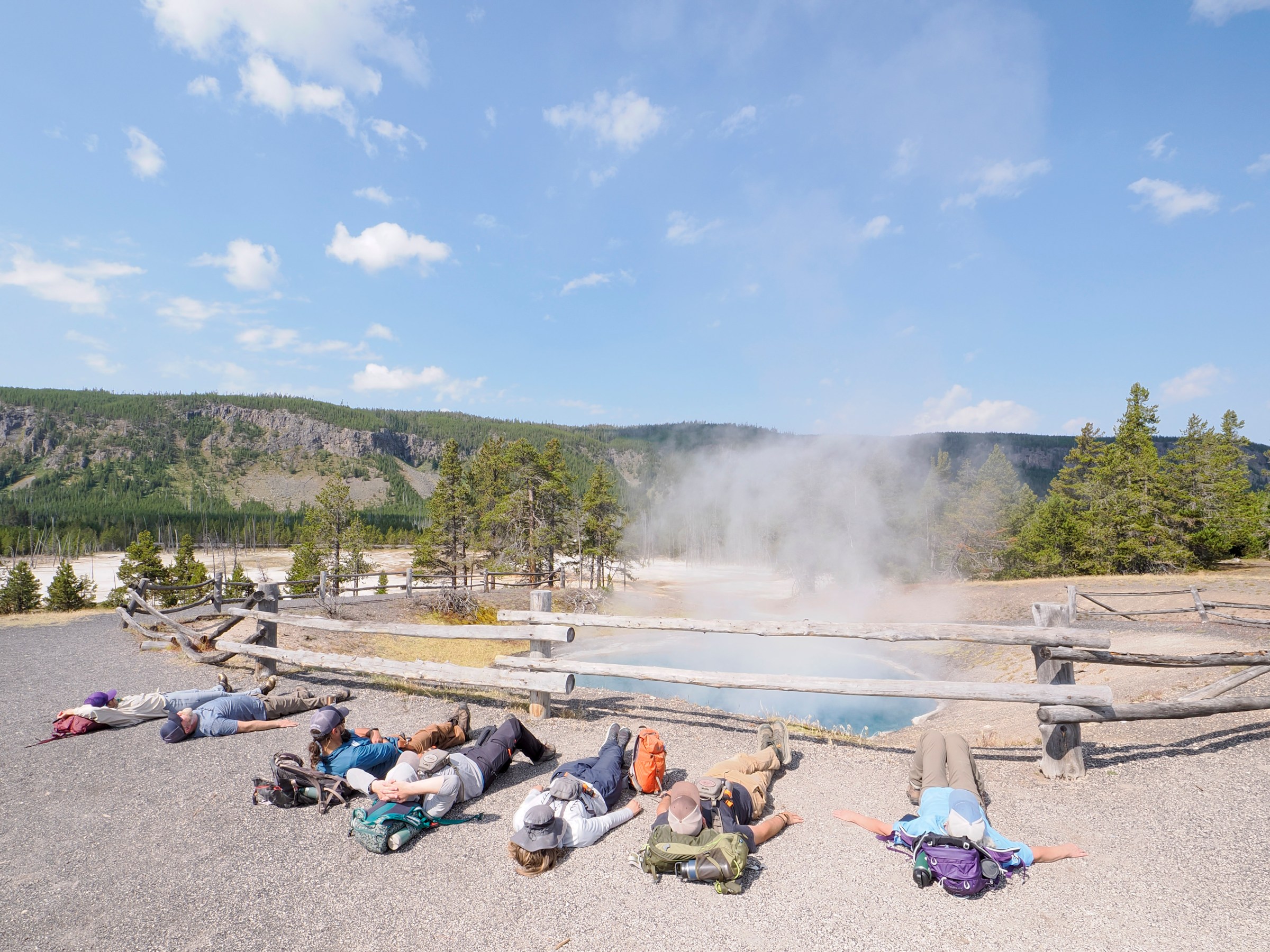 a group of people sitting at a beach