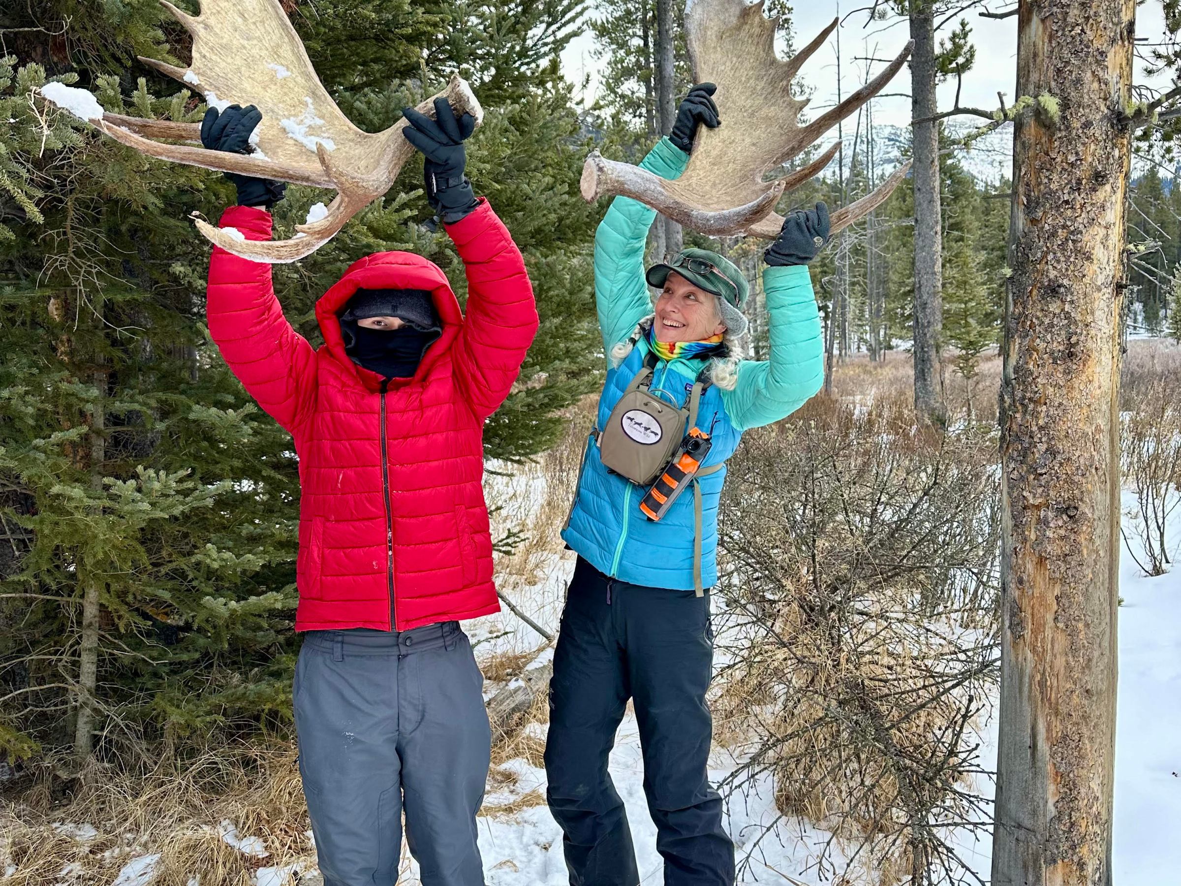 a couple of people that are standing in the snow