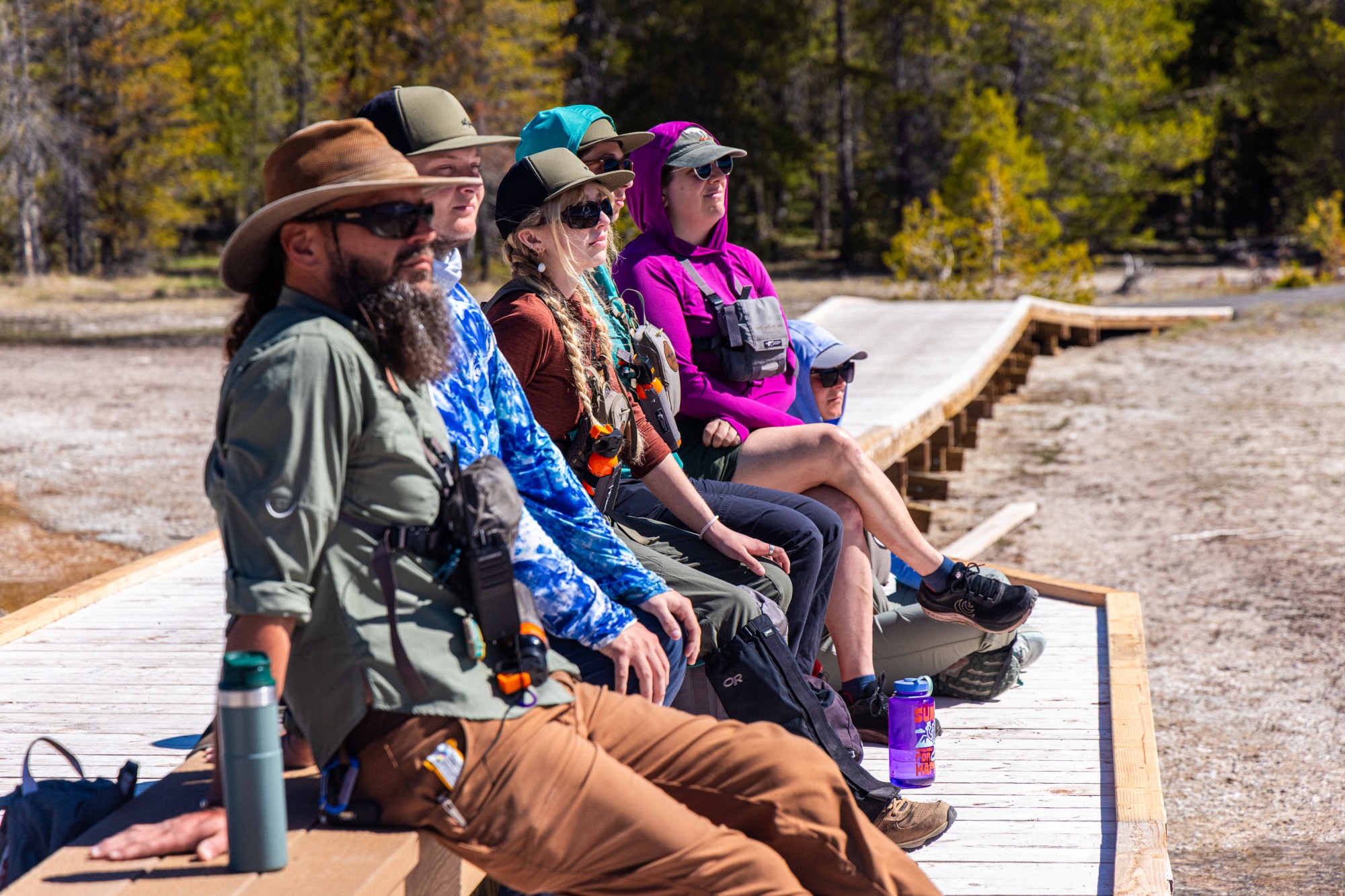 The Yellowstone Wild staff pondering the upcoming season as they anticipate an eruption of Daisy Geyser during training.